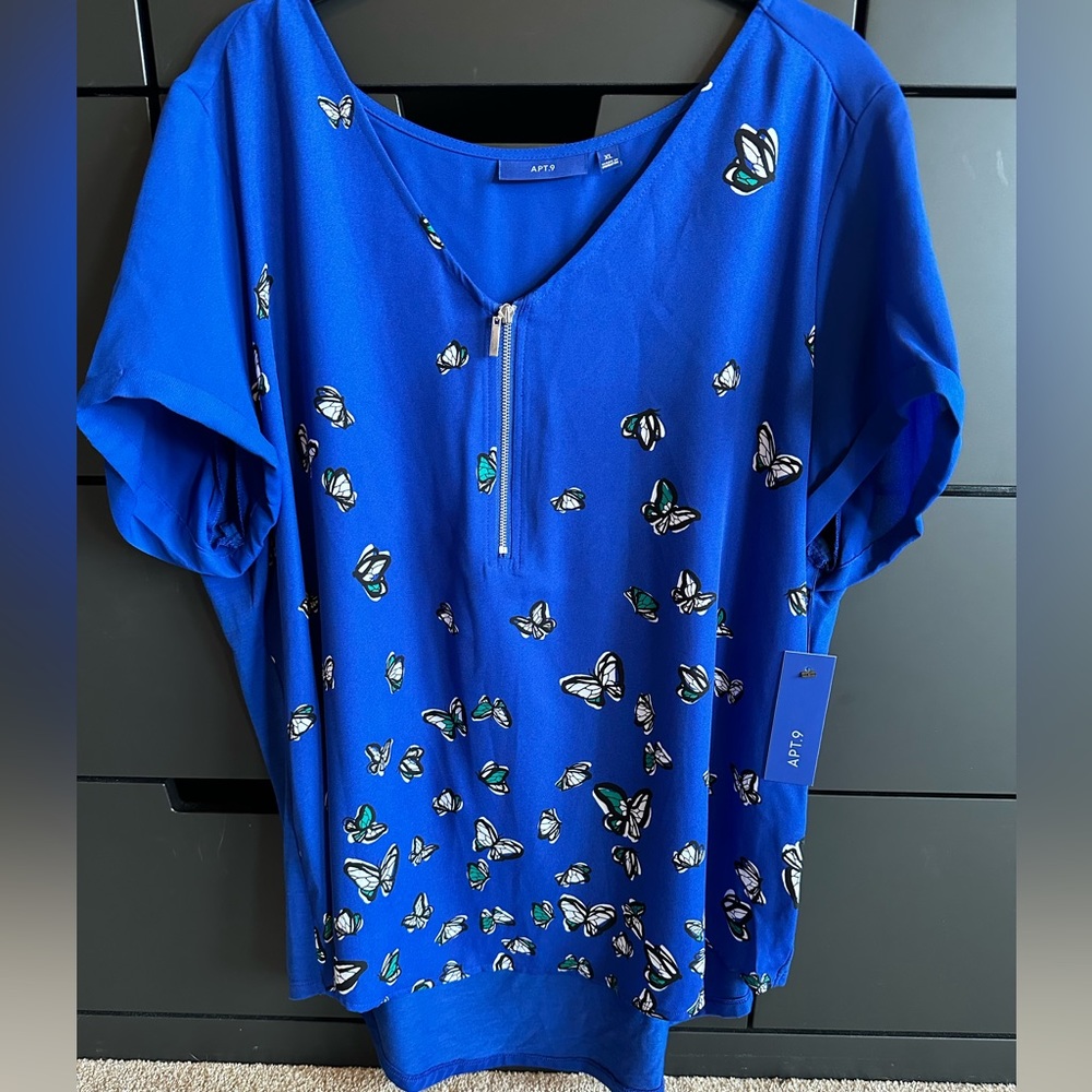 Bright blue butterfly print blouse.